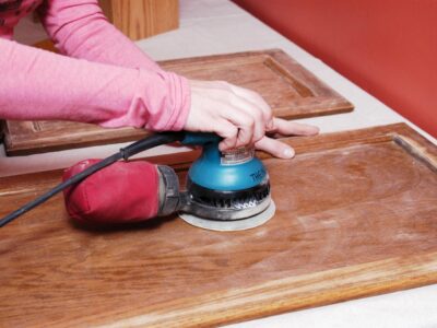 A woman is doing a cabinet refacing