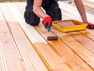 A handyman stains decks