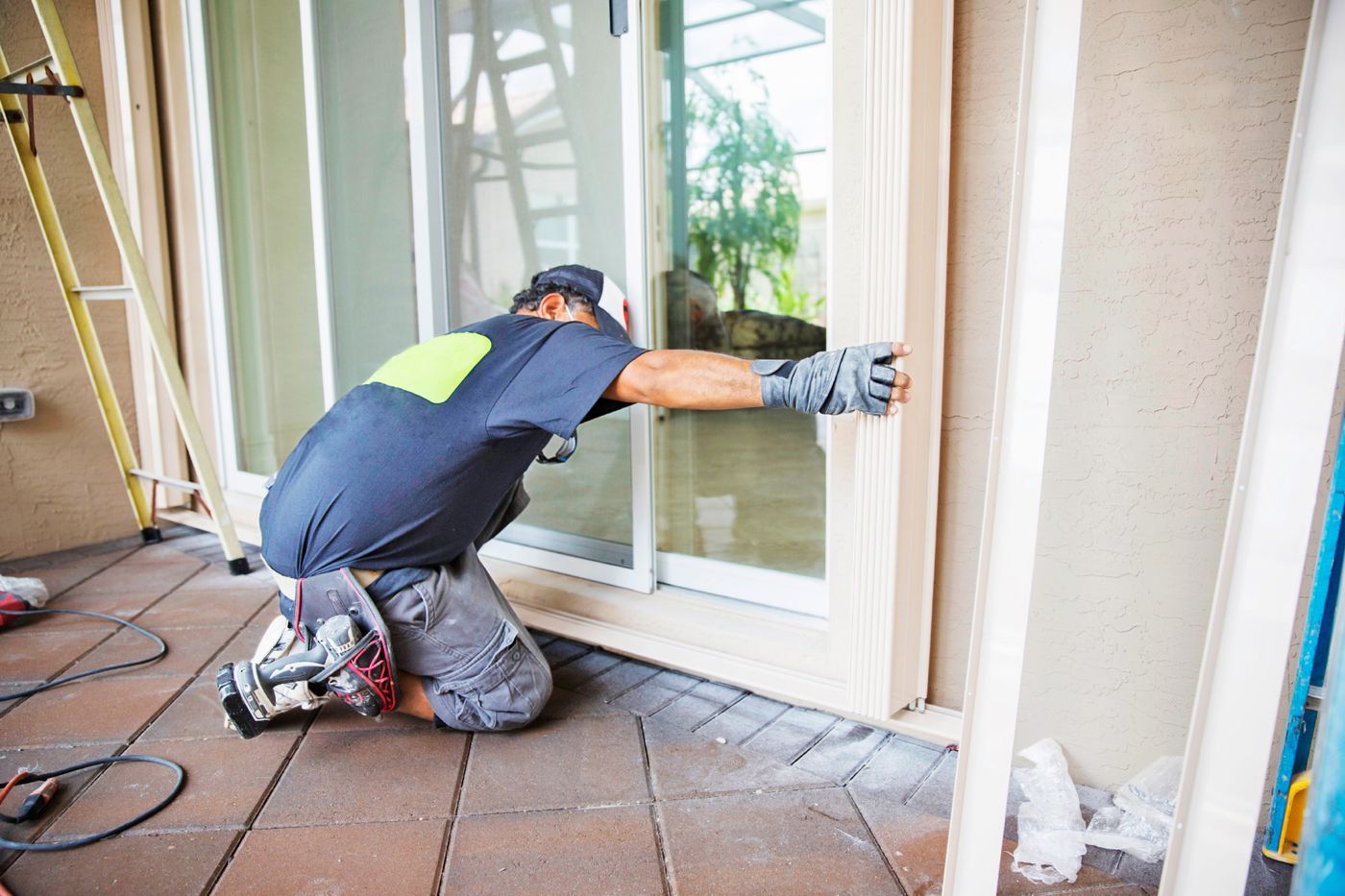 A handyman repairs a door frame