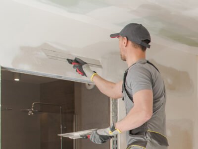 Worker fixes drywall