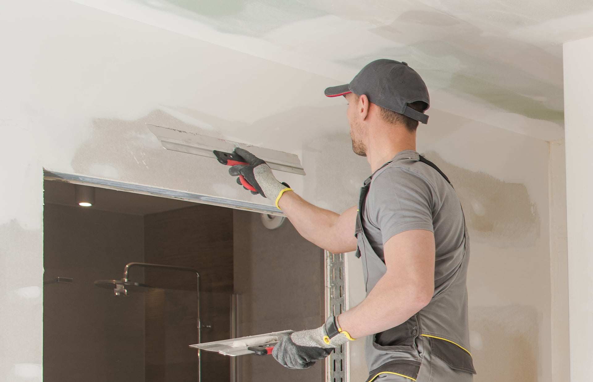 Worker fixes drywall