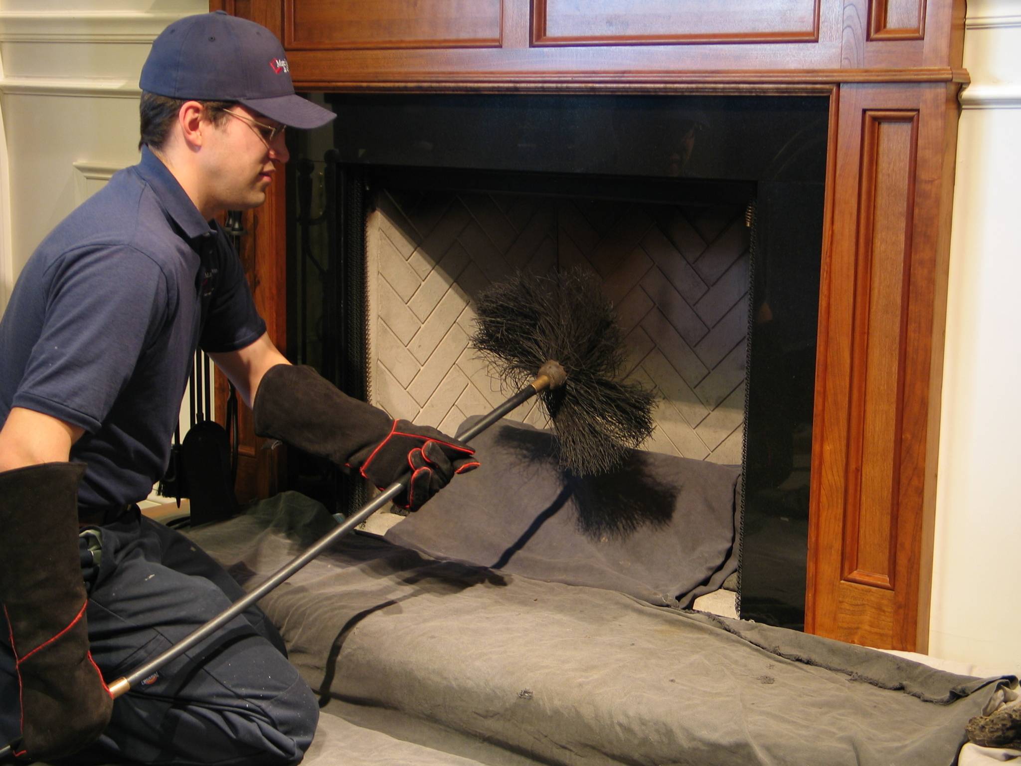 A worker cleans a fireplace