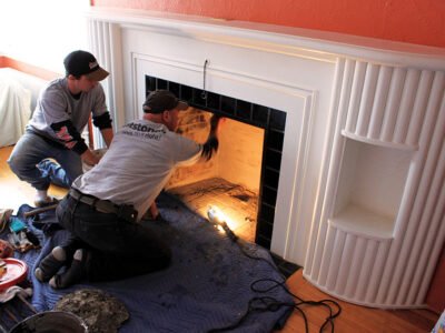 Workers install a fireplace