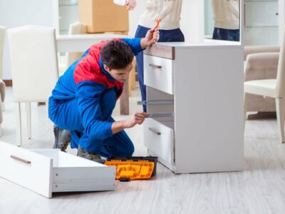 A handyman assembles furniture