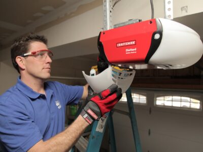 A worker installs a garage door opener