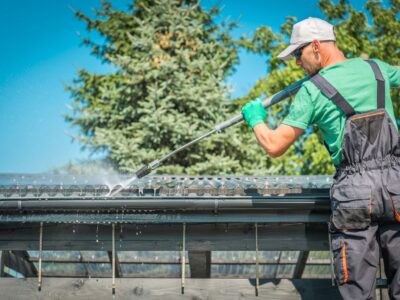 A worker cleans a gutter