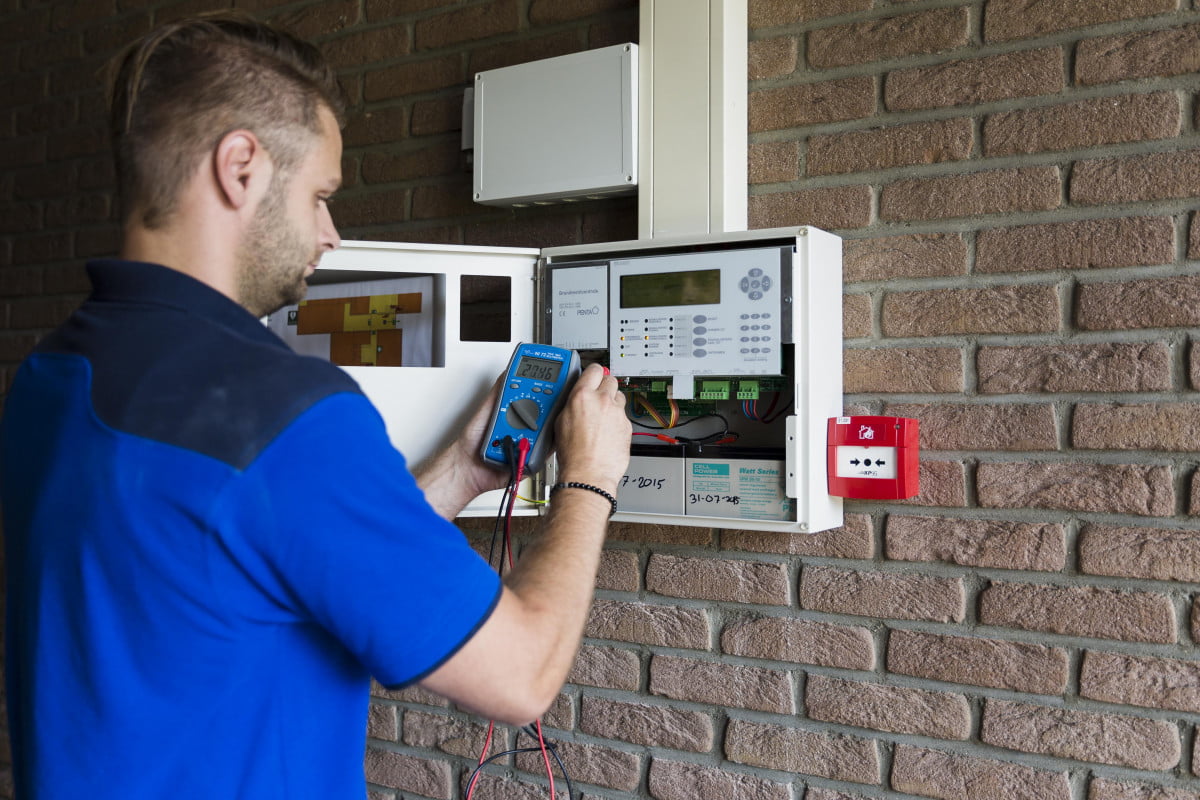 A handyman checks the sensors