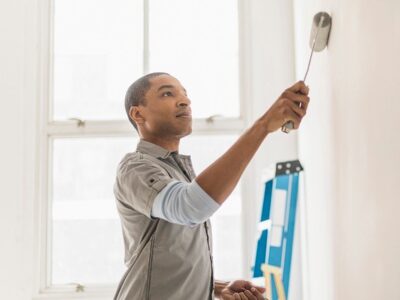 A painter paints a wall