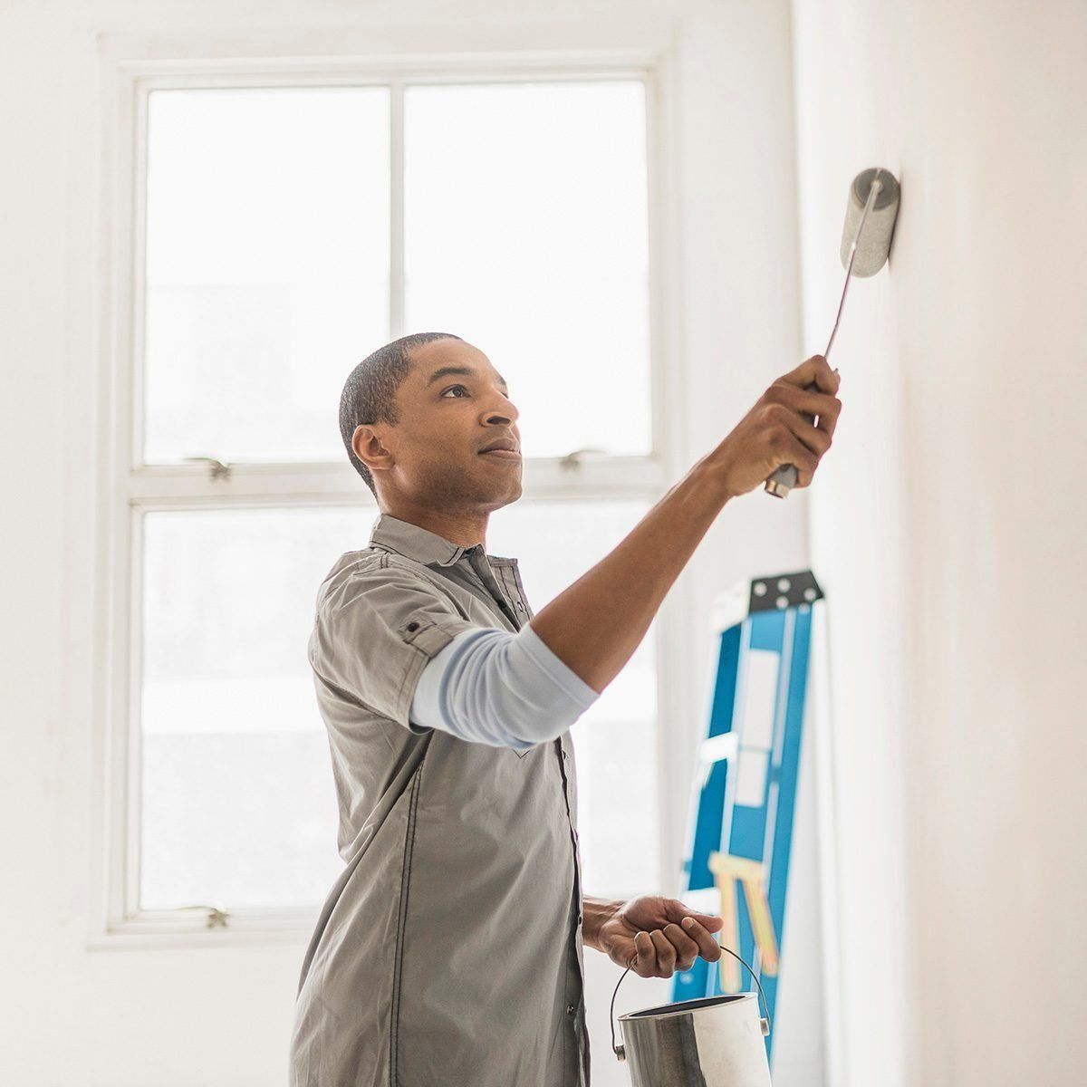 A painter paints a wall