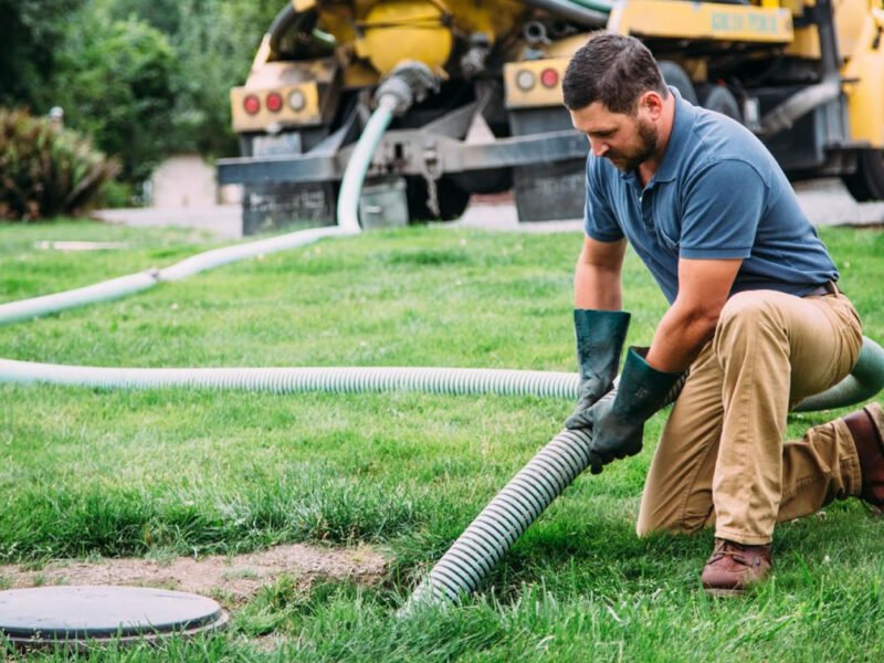 A worker repairs a septic system