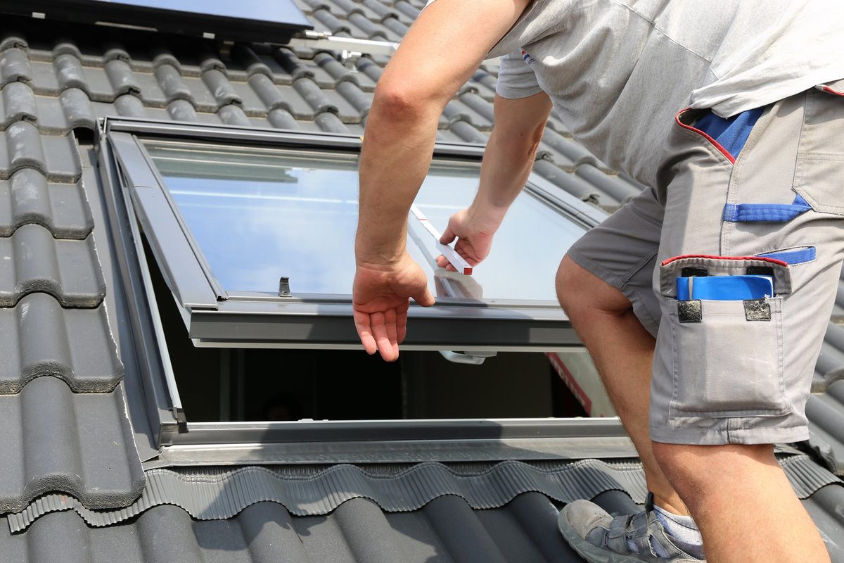A worker installs a skylight
