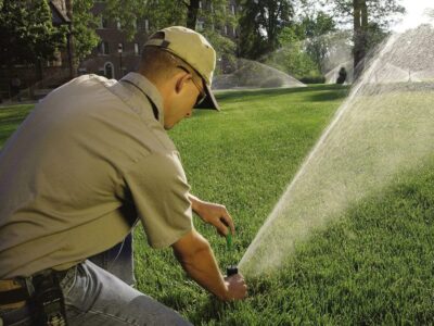 A worker installs a sprinkler system