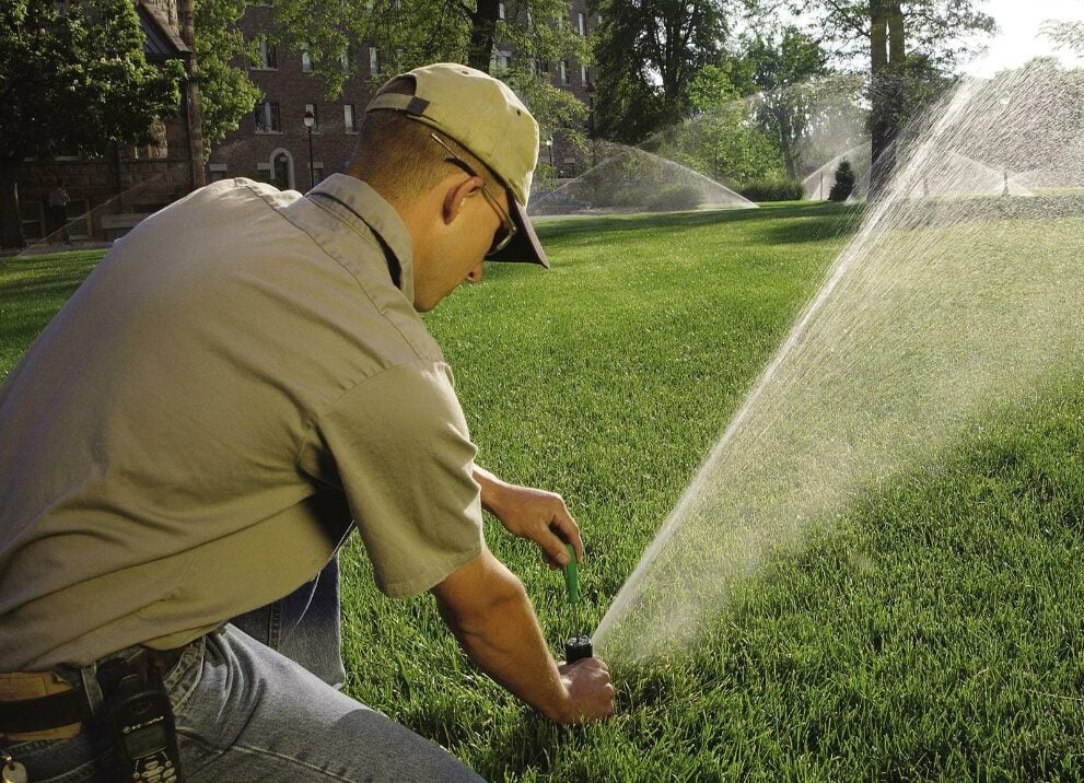 A worker installs a sprinkler system