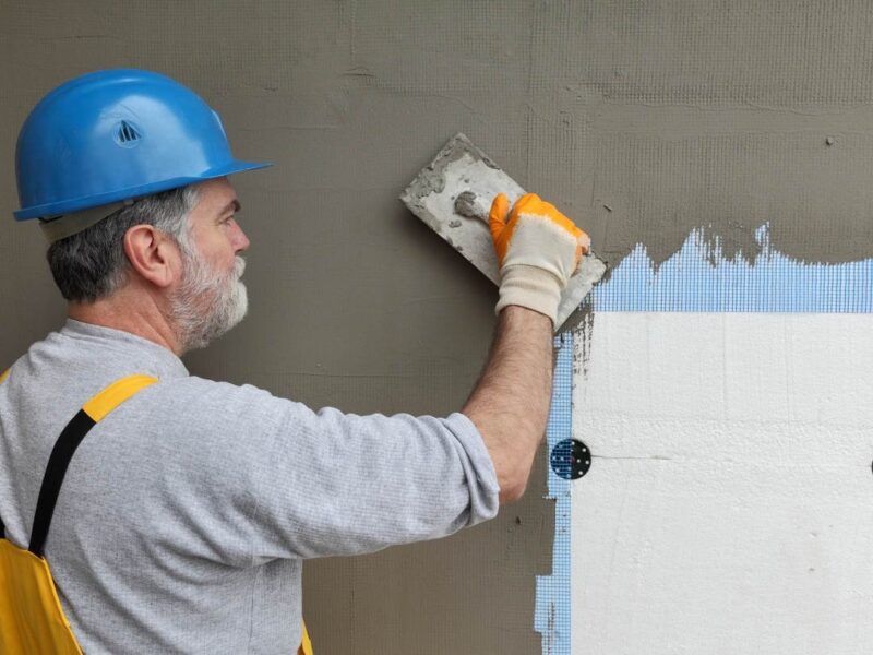 A worker restores stucco
