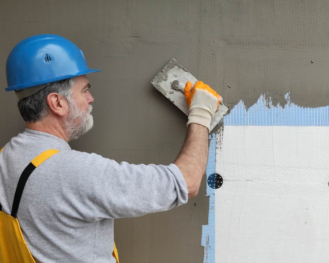 A worker restores stucco