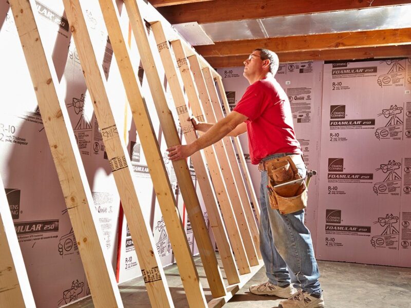 A builder is near a wall