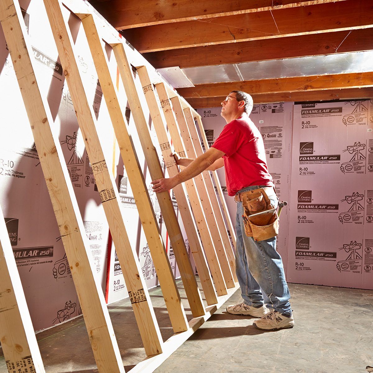A builder is near a wall