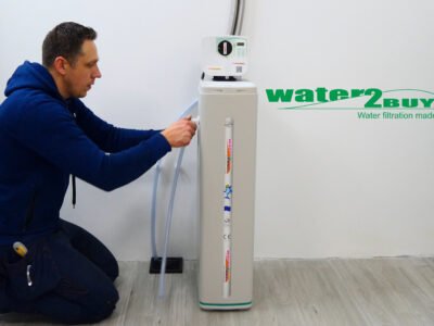 A handyman installs a water softener