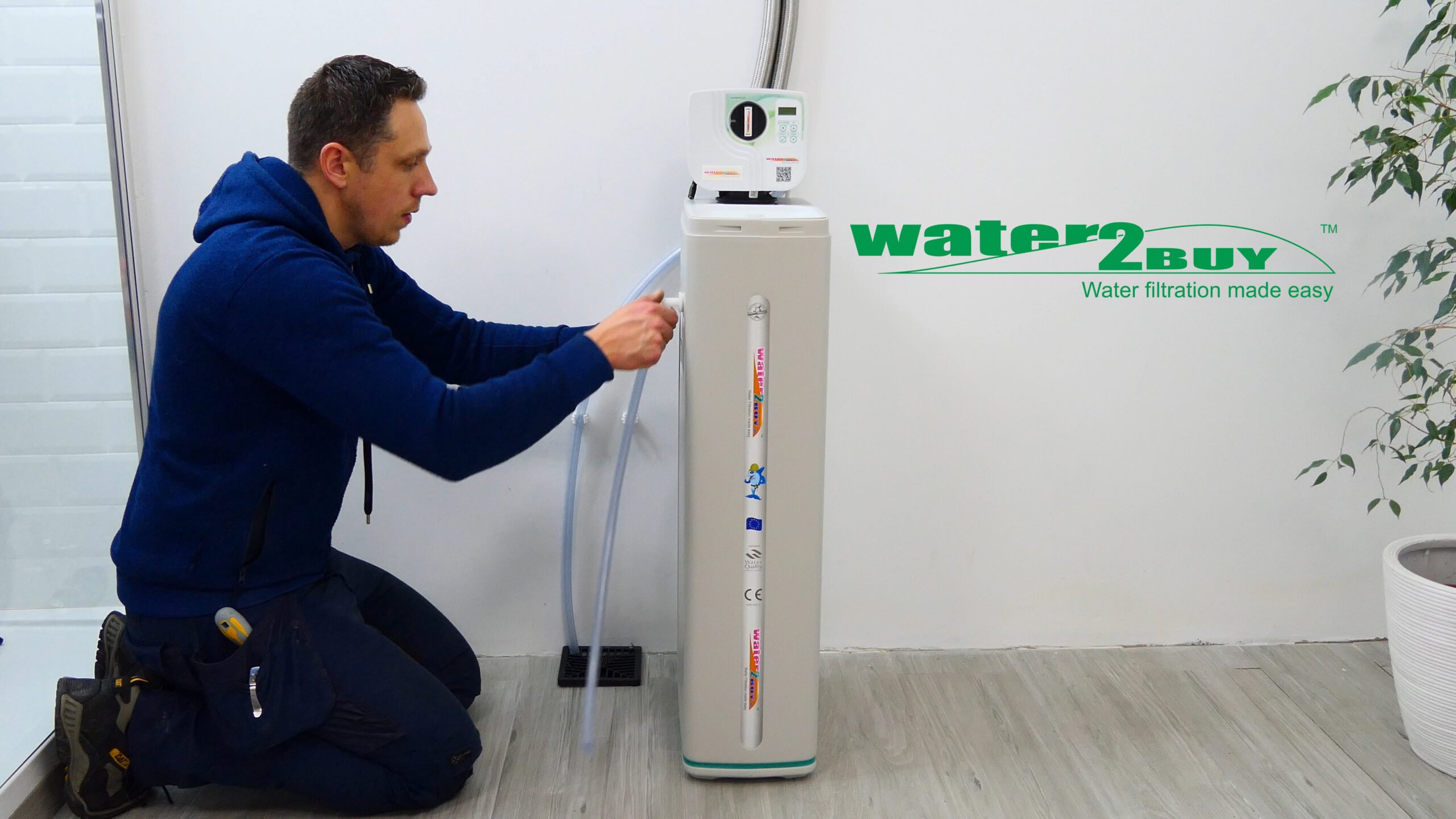 A handyman installs a water softener