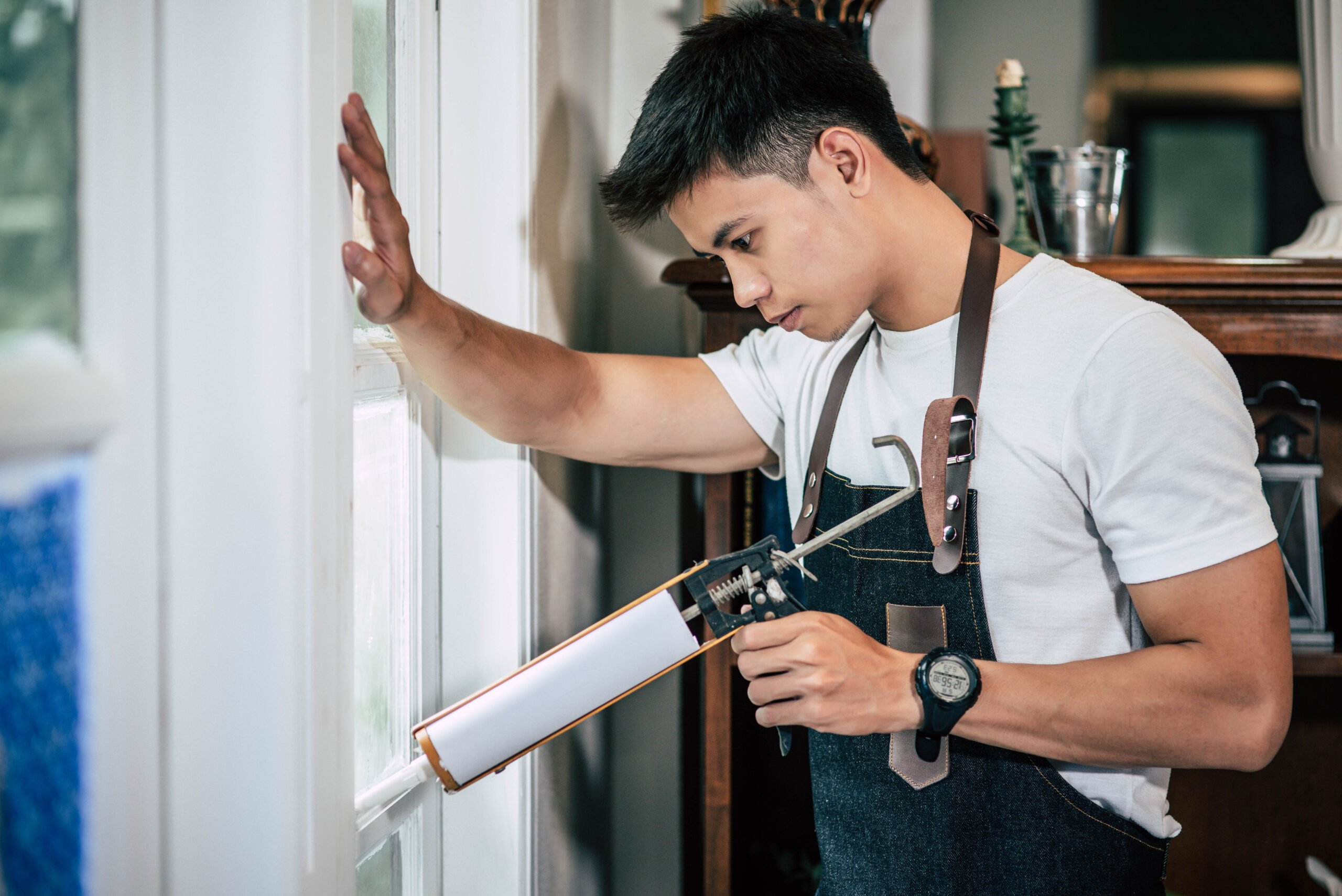 A worker repairs a window frame