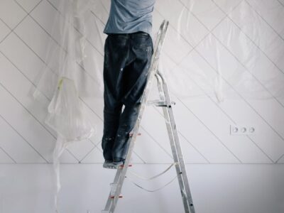 housepainter on ladder working in room